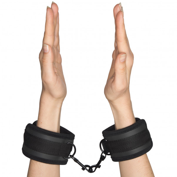 Obaie Padded Neoprene Handcuffs product held in hand 50